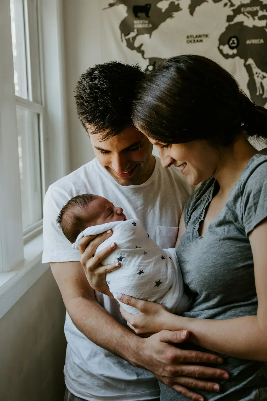Couple smiling with their newborn baby